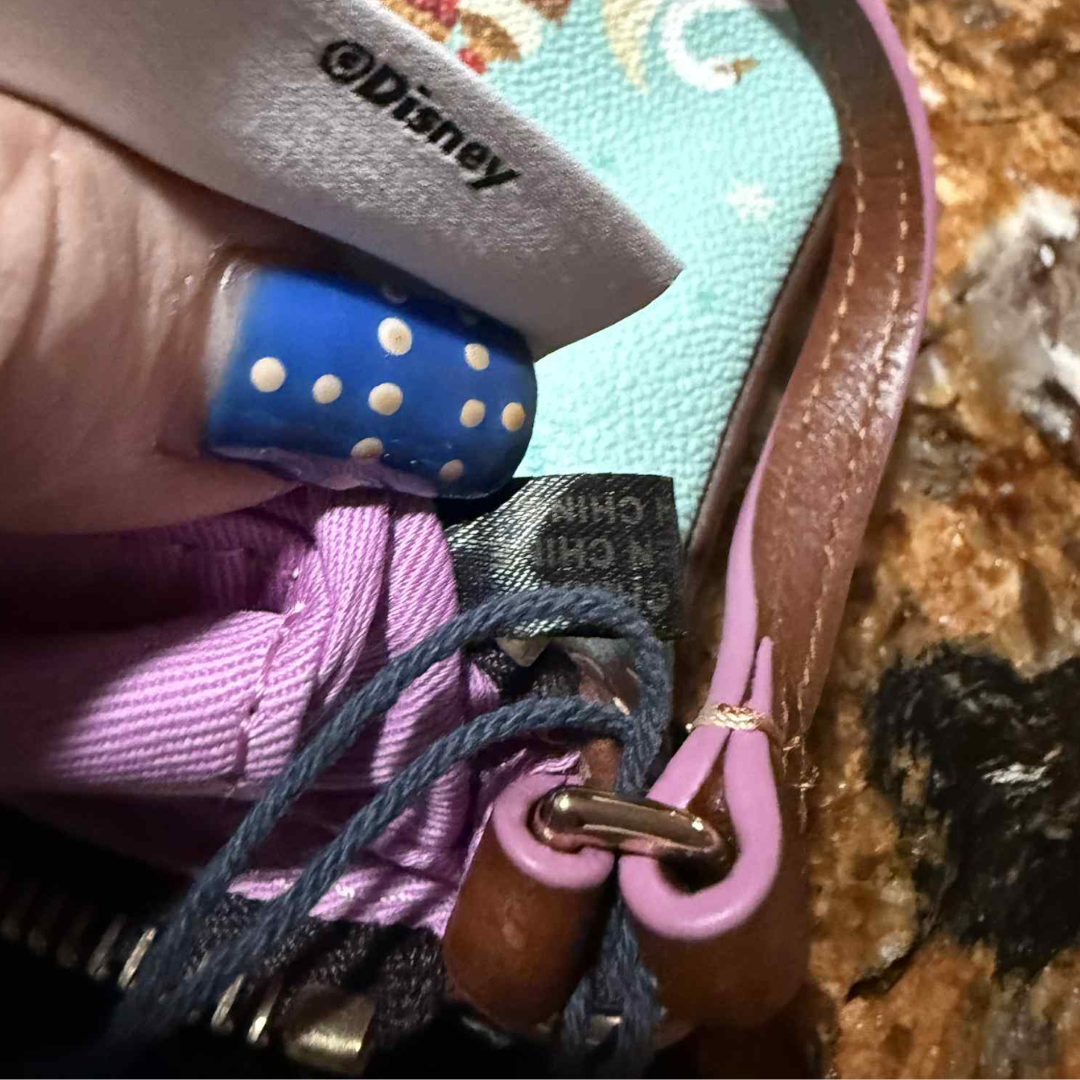 7 Close-up of manufacturing tag reading “Made in China” inside Disney Parks x Dooney & Bourke wristlet.