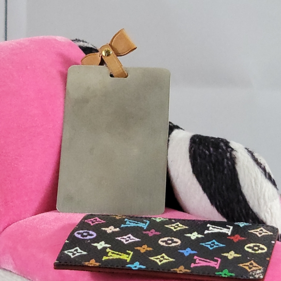 Back view of the Louis Vuitton Murakami Noir Mirror highlighting the polished reflective surface and vachetta leather bow attachment.