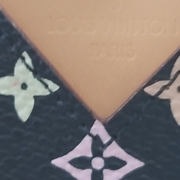 Close-up of the Louis Vuitton Paris stamp on the Murakami Noir Monogram Mirror Case showing craftsmanship and logo detail.
