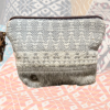 Close-up front detail of Myra Bag Patsy Pouch with woven texture and hide accent trim