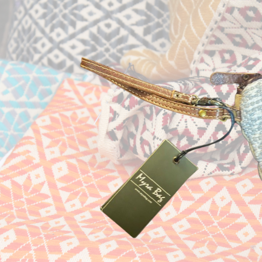 Leather wrist strap and Myra Bag tag attached to the Patsy Pouch