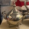 silverplate-sugar-bowl-ornate-footed-vintage.jpg Close-up of the vintage silverplated sugar bowl with ornate handles and decorative feet.