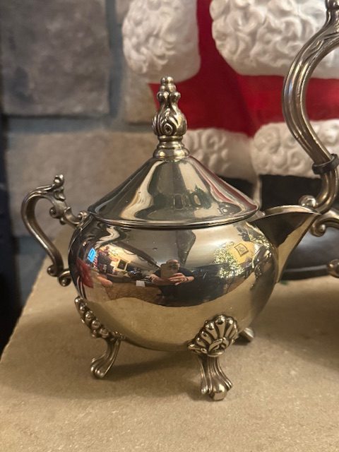 silverplate-sugar-bowl-ornate-footed-vintage.jpg Close-up of the vintage silverplated sugar bowl with ornate handles and decorative feet.